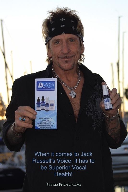 A man holding up a bottle of jack russell's voice.
