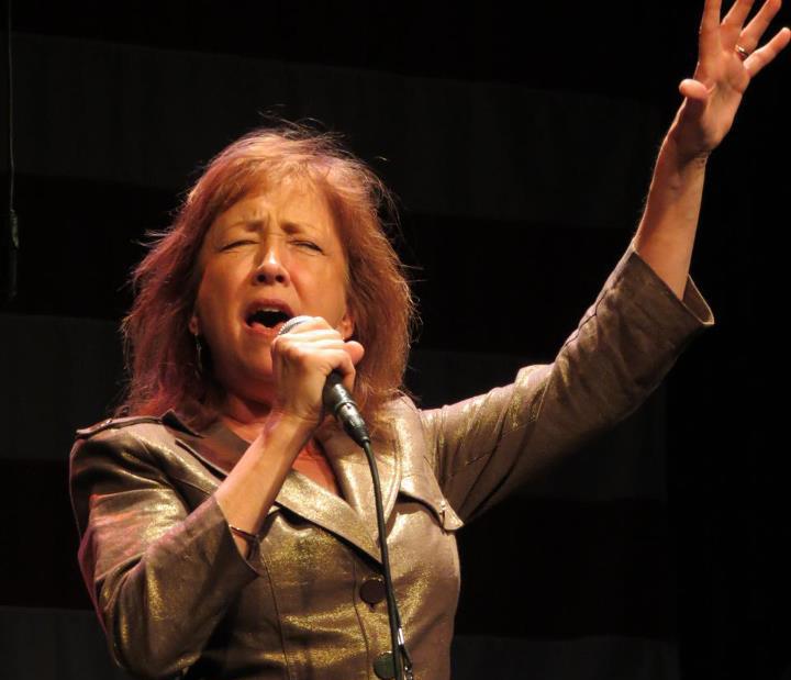 A portrait of Judy Rodman singing