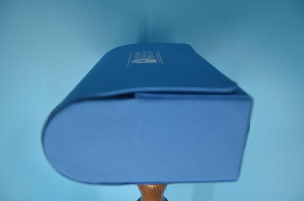 A SVH Travel Pack Case with a wooden handle on a blue background.