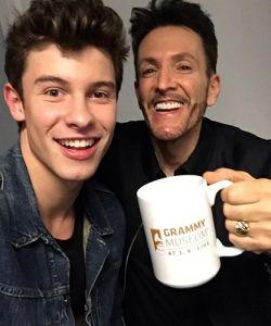 A man holding a cup with Shawn Mendes